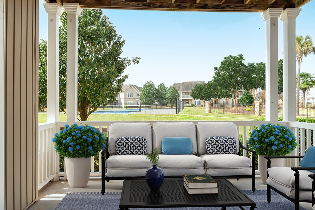 a living room with a couch and a coffee table on a porch