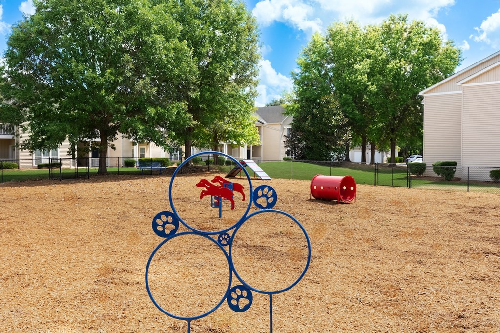 a playground with a seesaw and other toys in a park