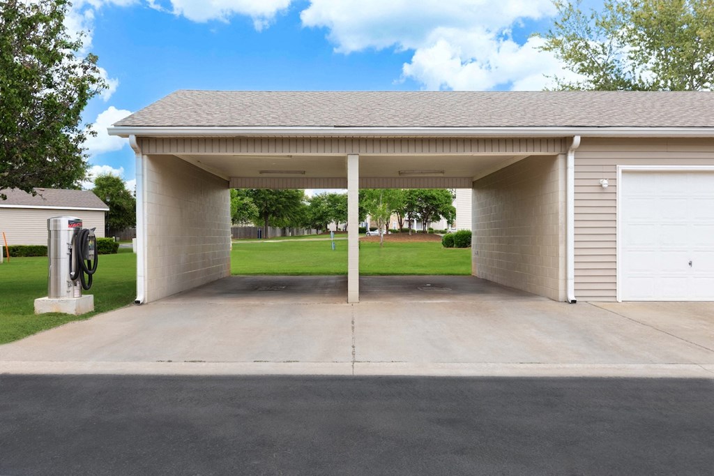 a car garage with a driveway and a white garage door