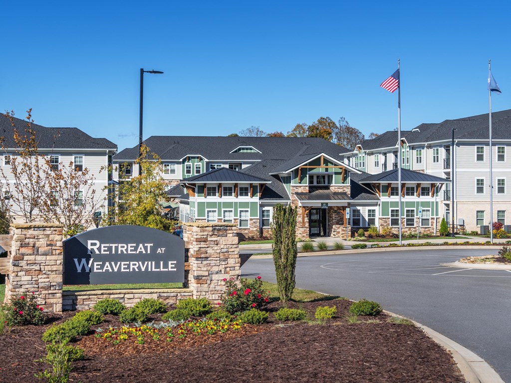 the view of retreat at weaverville with a sign in front of a building