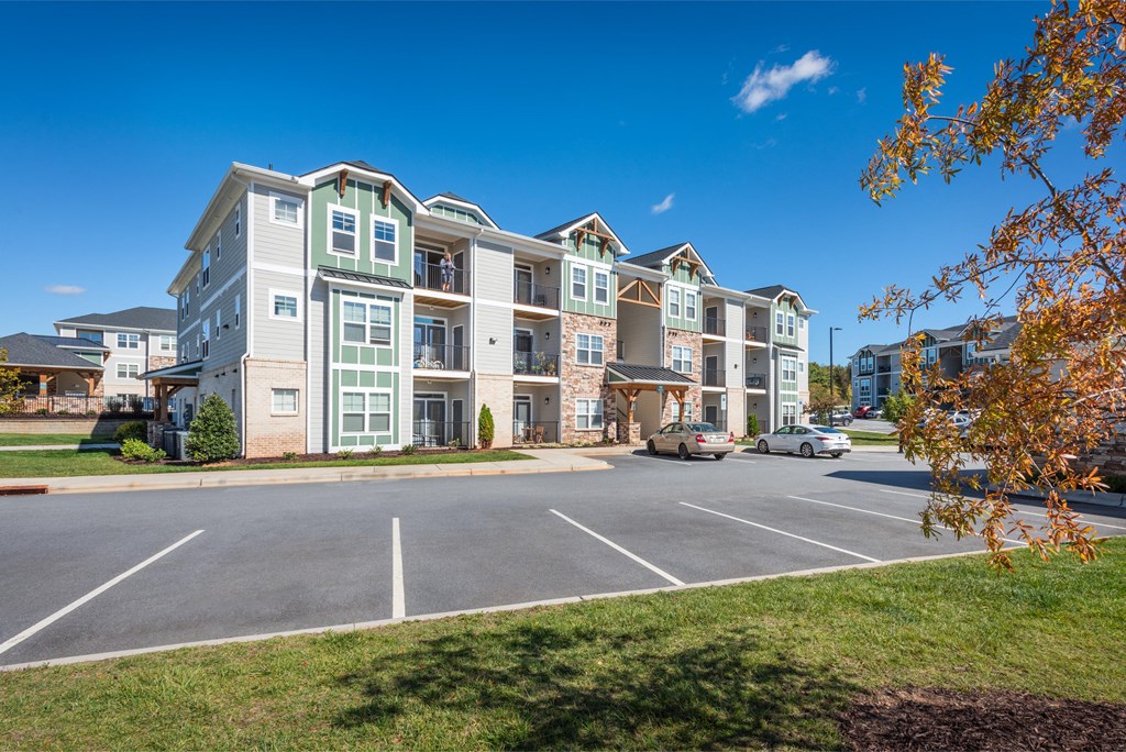an empty parking lot in front of an apartment building