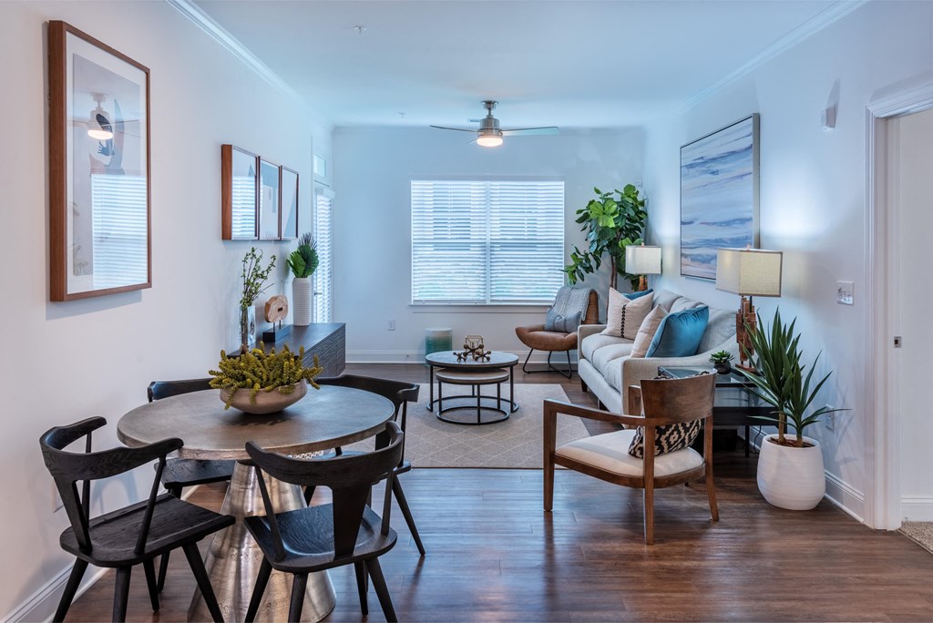 a living room with a couch and a table and chairs