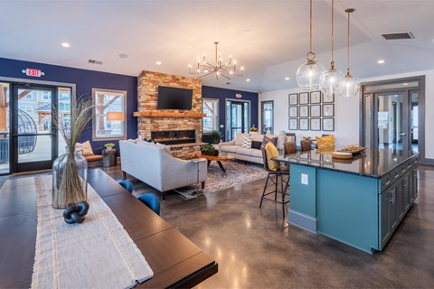 a large living room with a kitchen and a fireplace