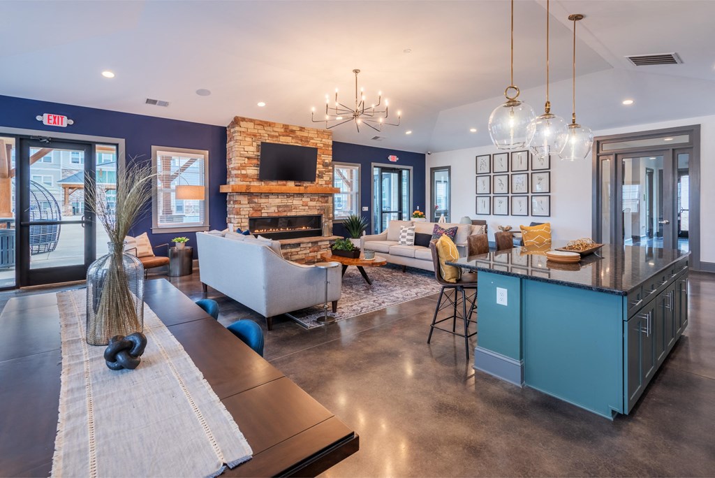 a large living room with a kitchen and a fireplace