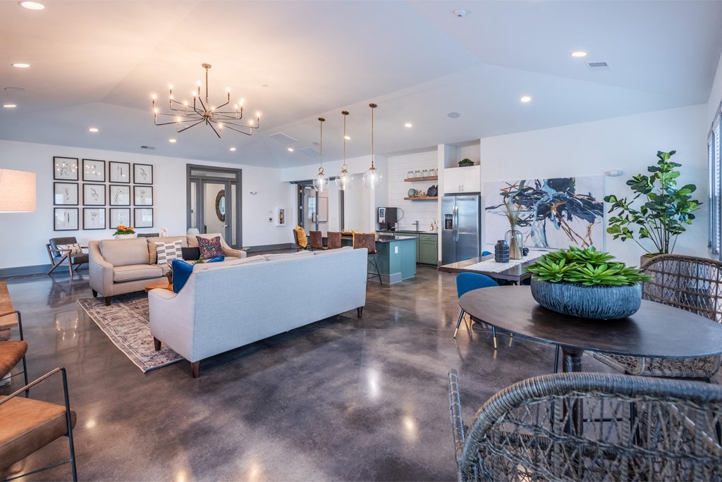 a living room with couches and chairs and a table