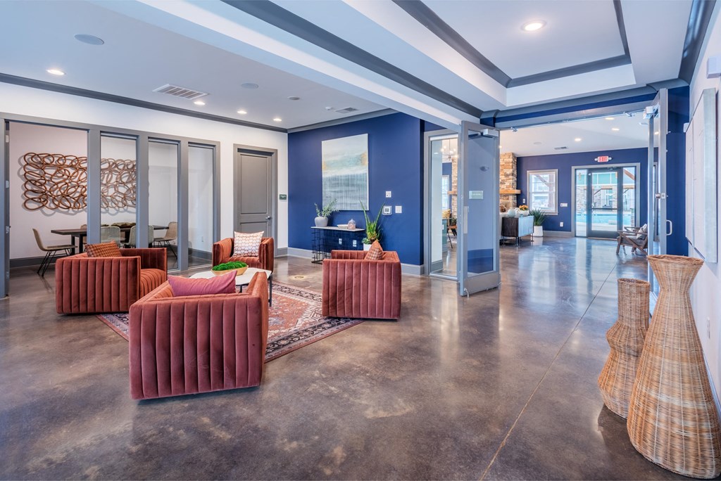 a lobby with couches and chairs and glass doors