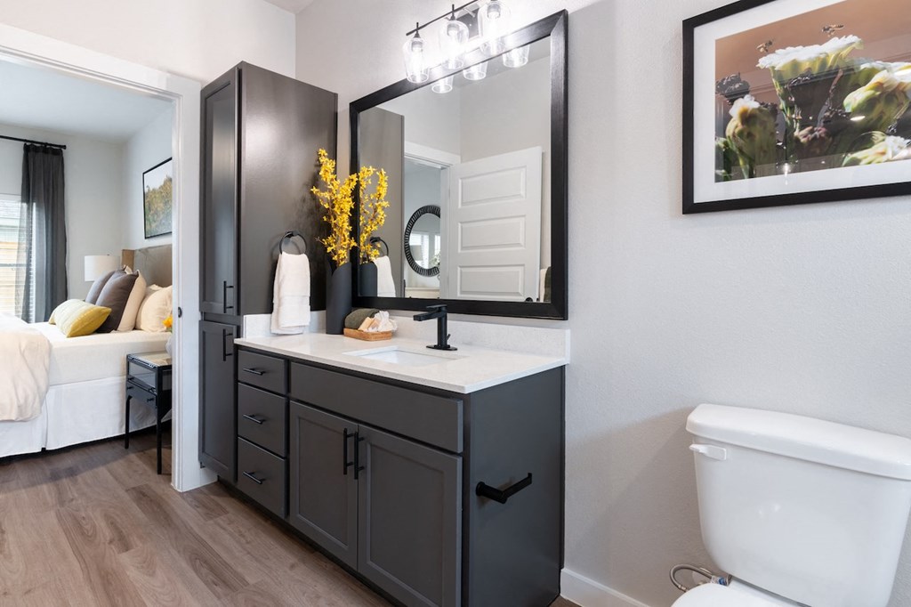 A bathroom with a white tub and a large mirror.