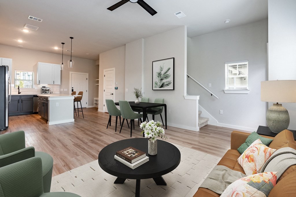 A living room with a black coffee table and a green chair.