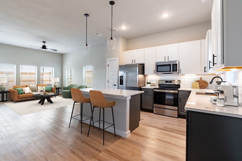 A modern kitchen with a bar area and a dining area.