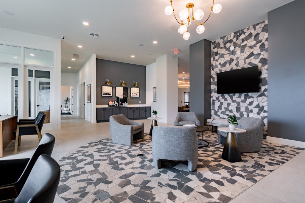 A modern living room with a grey and white tiled floor and a chandelier hanging from the ceiling.
