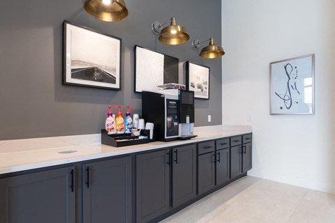 A kitchen with dark cabinets and a white countertop.
