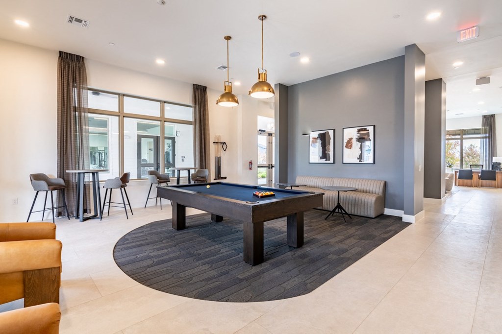 A room with a pool table and a couch.