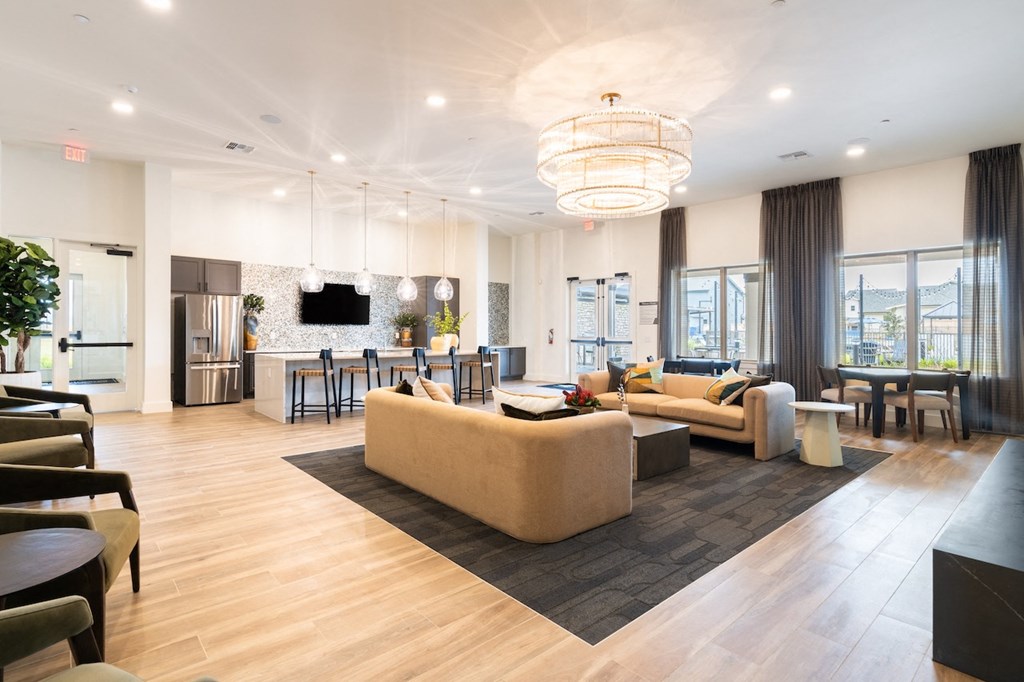 A spacious living room with a large couch and a television.