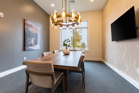 A dining room with a wooden table and chairs.