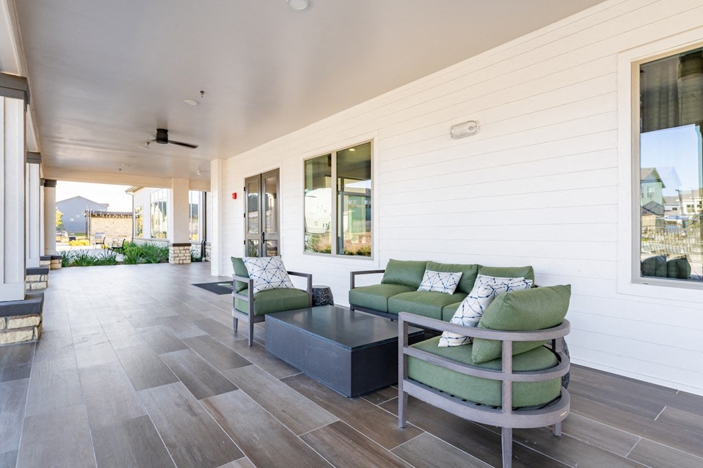 A modern living room with a green couch and a grey coffee table.