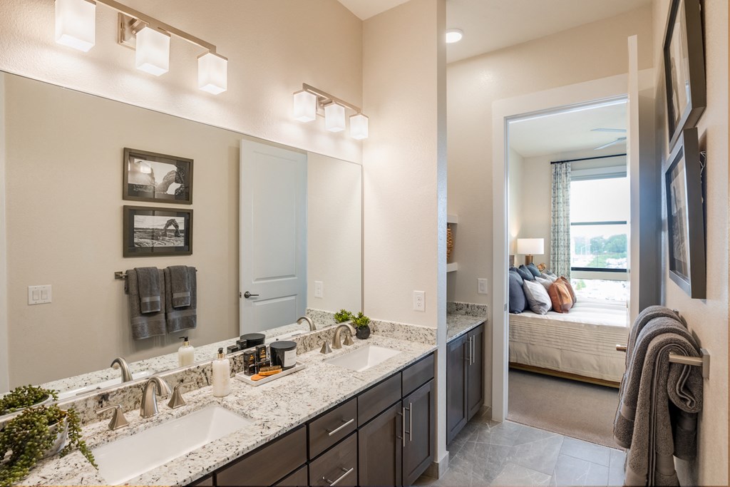 A bathroom with a double sink vanity and a mirror above it at 27Seventy Lower Heights apartments in Houston, TX.