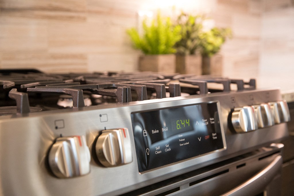 A stainless steel gas stove with a digital display at 27Seventy Lower Heights apartments in Houston, TX.