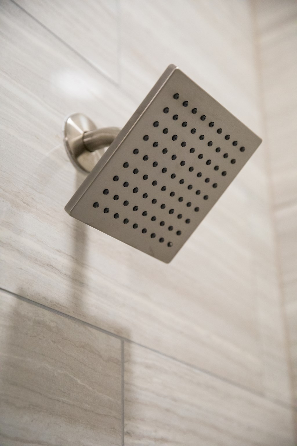 A shower head mounted on a wall at 27Seventy Lower Heights apartments in Houston, TX.
