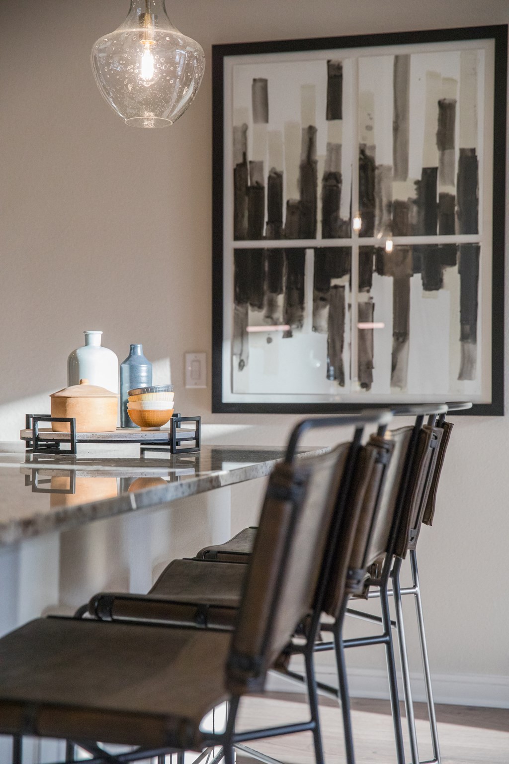 A row of chairs are lined up in front of a painting at 27Seventy Lower Heights apartments in Houston, TX.