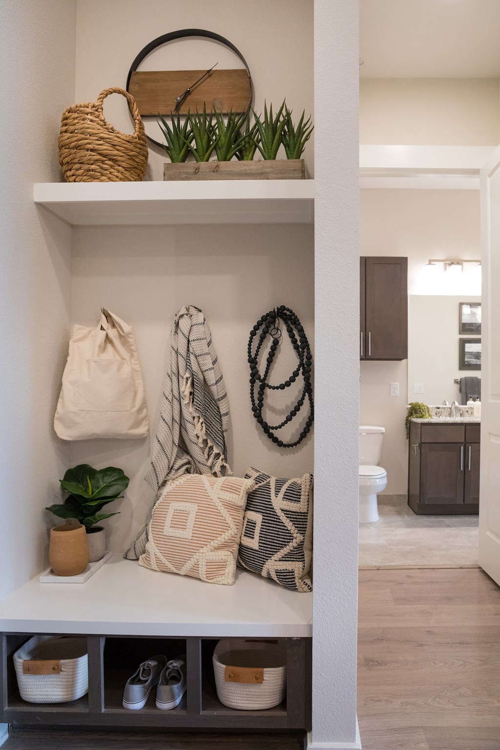 A white built in shelf with a basket, pillow, and shoes on it at 27Seventy Lower Heights apartments in Houston, TX.