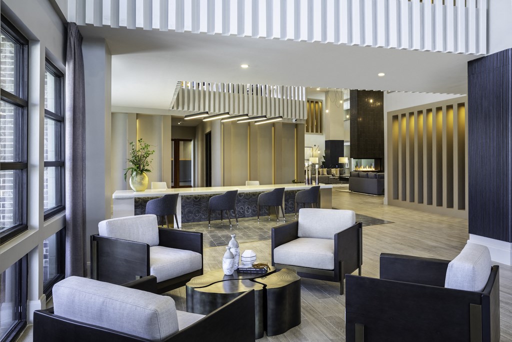 A modern clubhouse with black and white furniture at 27Seventy Lower Heights apartments in Houston, TX.