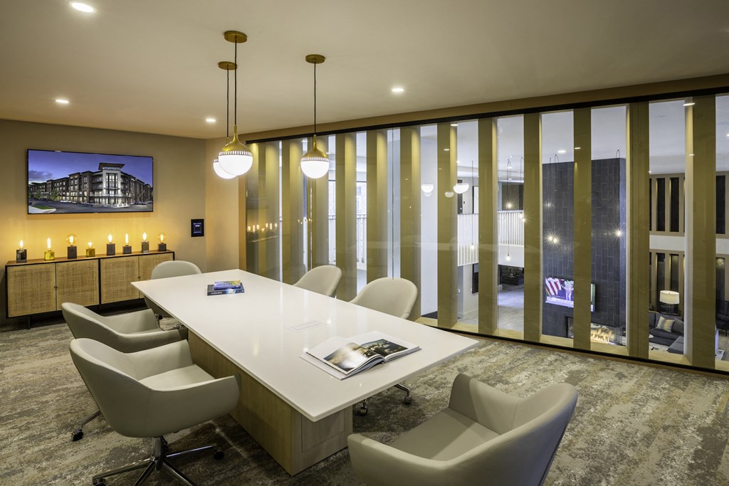 A conference room with a long table and chairs at 27Seventy Lower Heights apartments in Houston, TX.