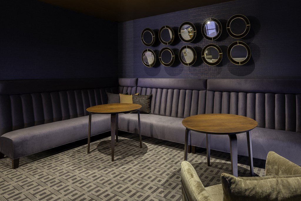 A seating area with booths and tables at 27Seventy Lower Heights apartments in Houston, TX.