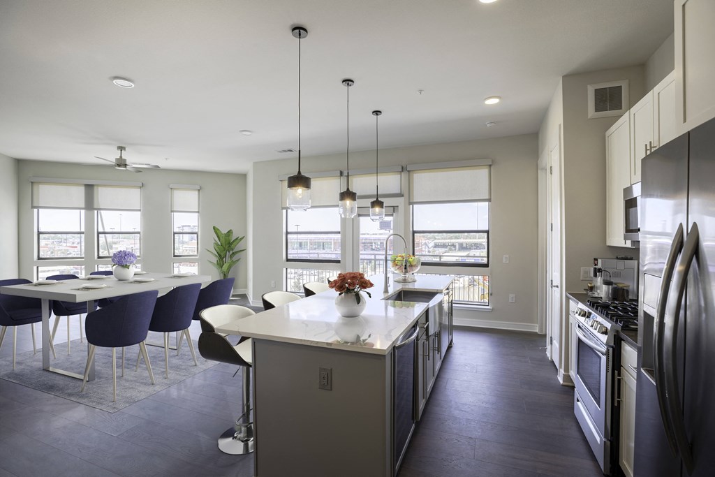 A modern kitchen with a dining table and chairs at 27Seventy Lower Heights apartments in Houston, TX.