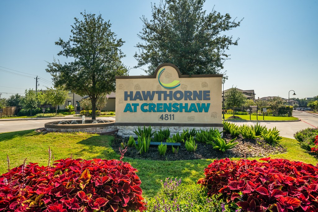 the sign at hawthorne with plants and trees
