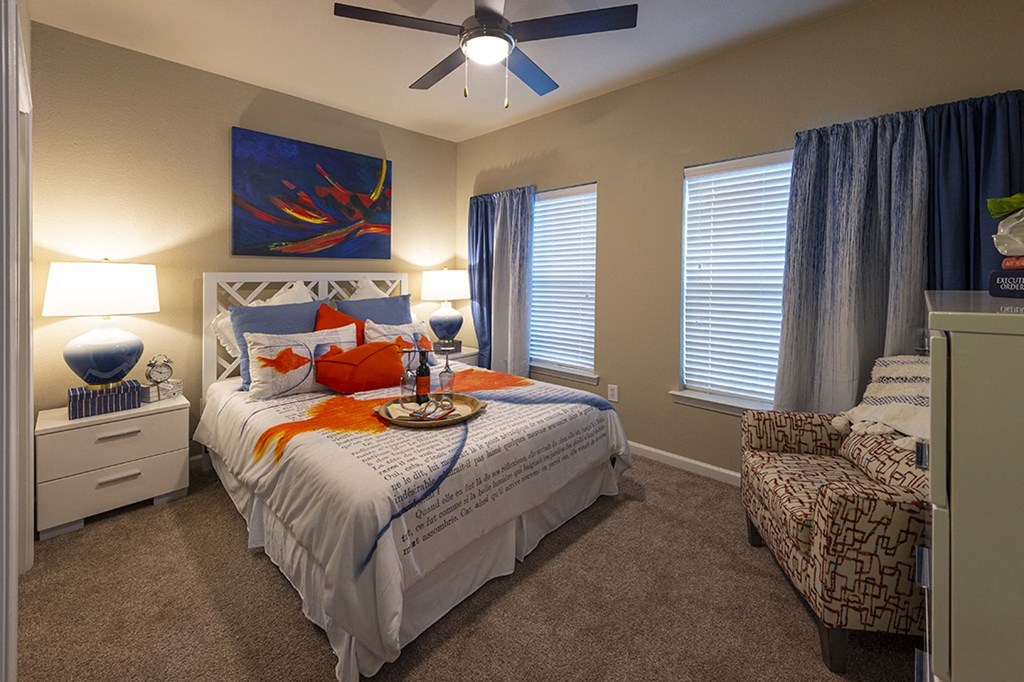 Two Bedroom Apartments in Myrtle Beach SC - Lattitude @ The Commons - Bedroom With a Ceiling Fan, Plush Carpeting, and Large Windows