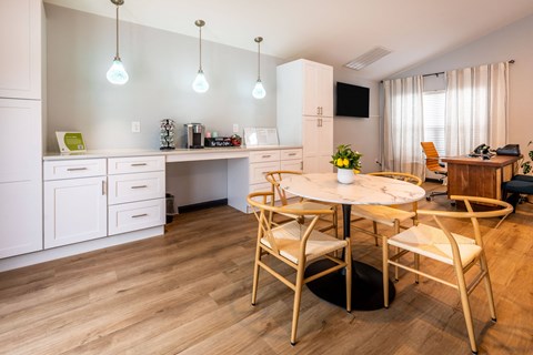 a kitchen and dining room with a table and chairs