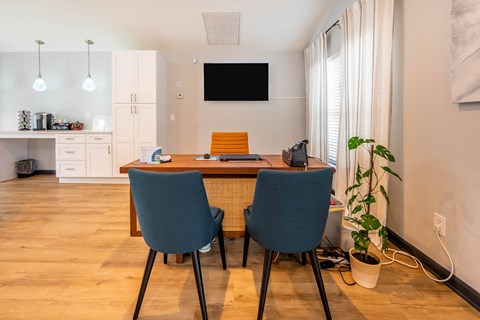a dining room with a table and chairs and a television