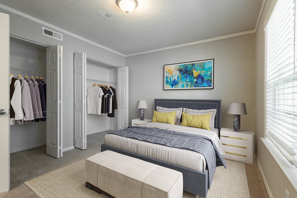 a bedroom with a large bed and a walk in closet