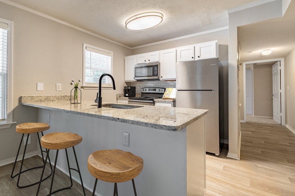 a kitchen with a breakfast bar and stools