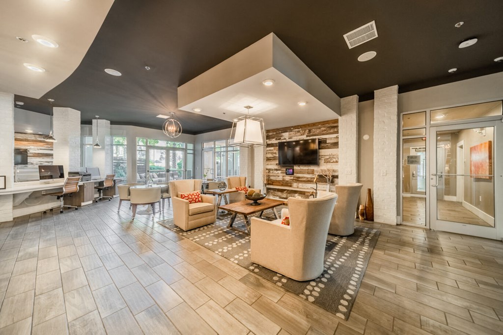 a living room with couches and chairs and a tv