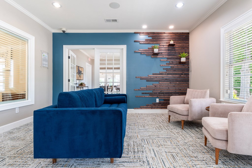 a living room with a blue couch and chairs