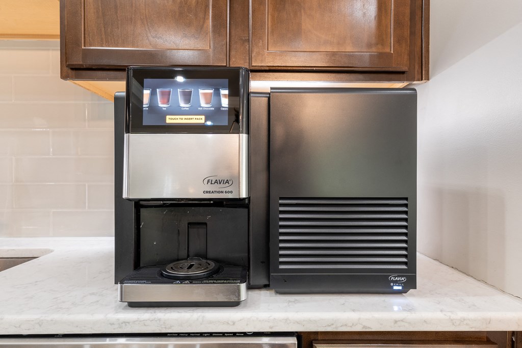a coffee maker and a refrigerator on a kitchen counter