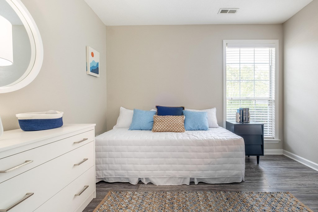 a bedroom with a bed and a dresser in a 555 waverly unit