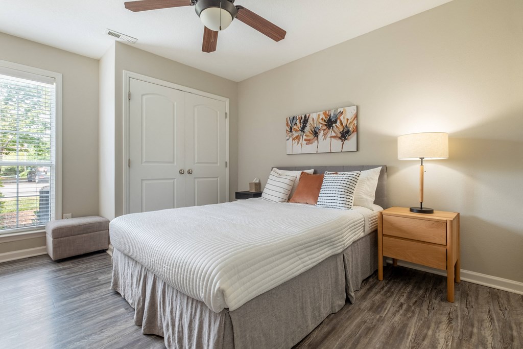 a bedroom with a large bed and a ceiling fan