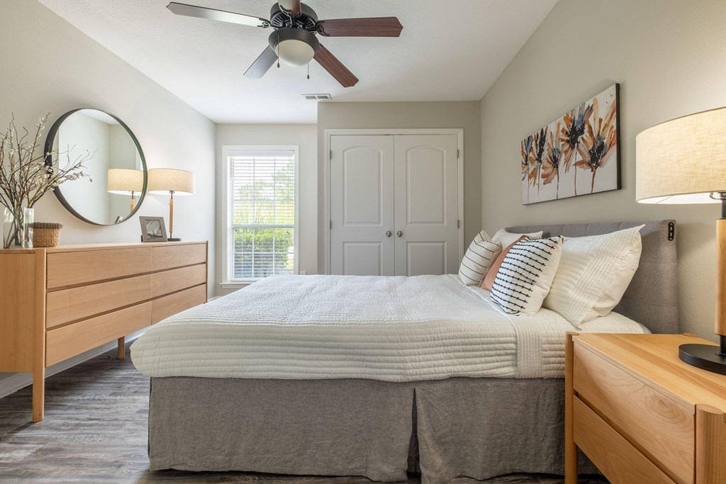 a bedroom with a large bed and a ceiling fan