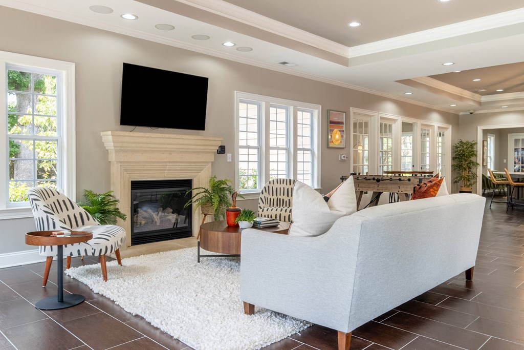 a living room with a fireplace and a tv above it
