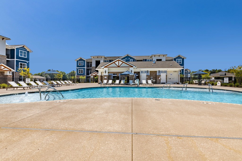 a large swimming pool with a building in the background