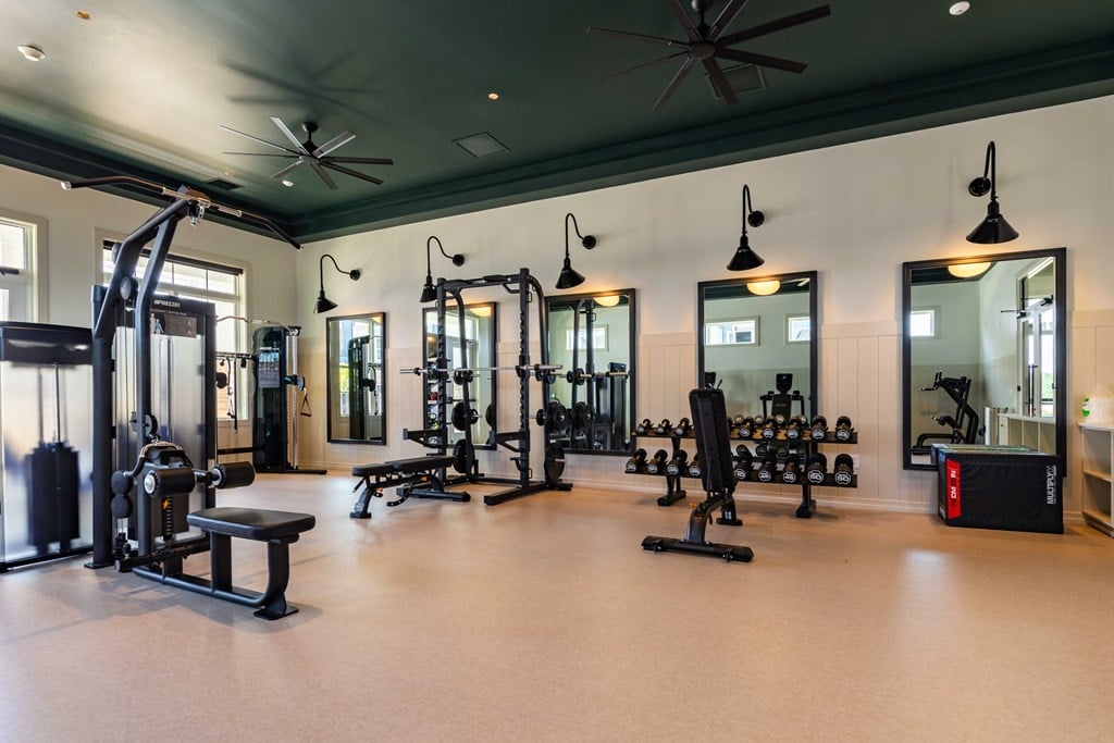 a fitness room with weights and other exercise equipment