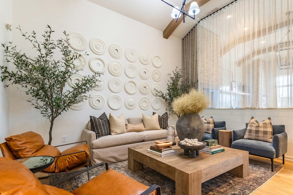 a living room with couches and chairs and a table