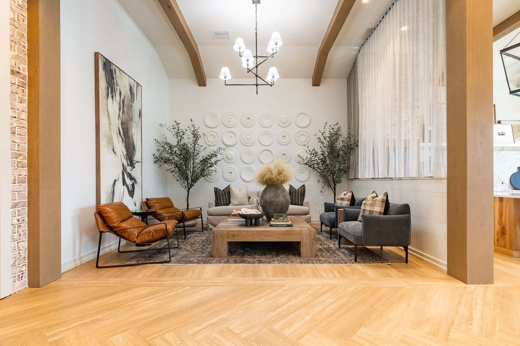 a living room with couches and chairs and a table