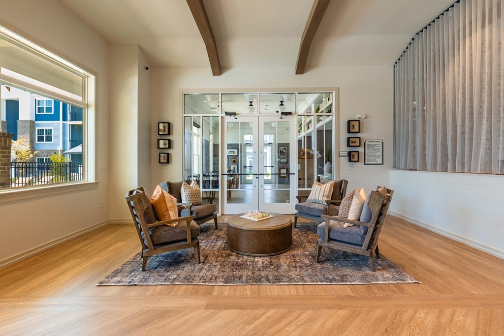 a living room with chairs and a round table