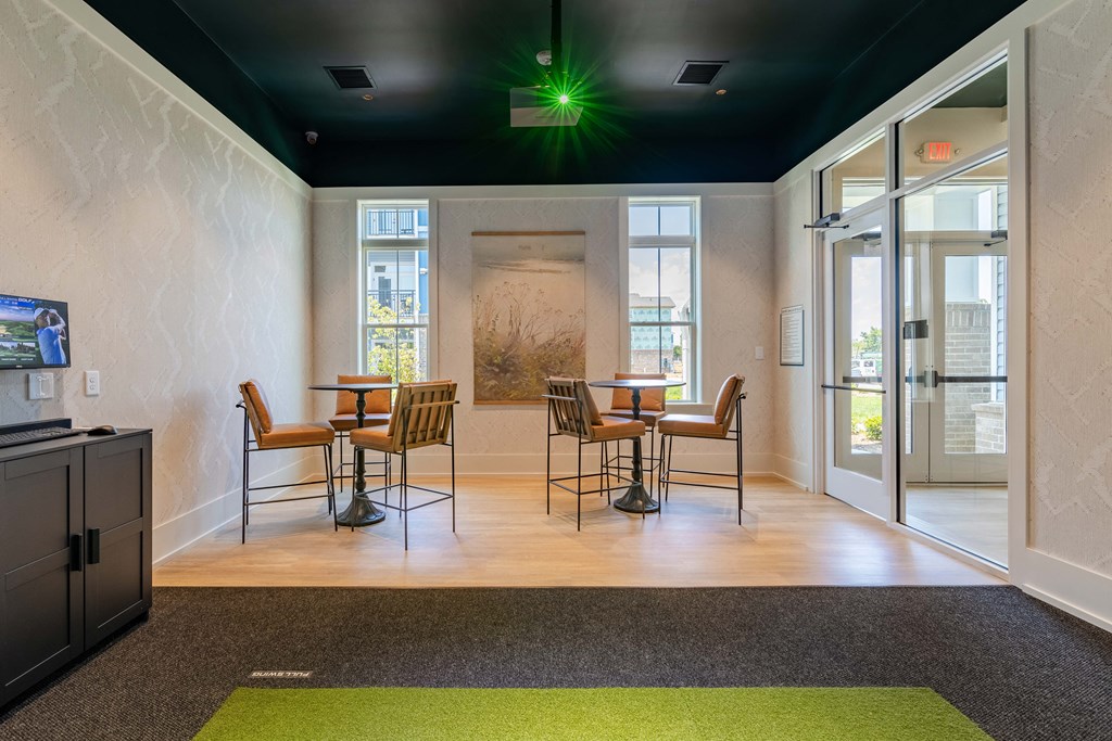 a conference room with a table and chairs and a tv