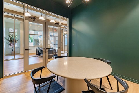 a conference room with a round table and chairs