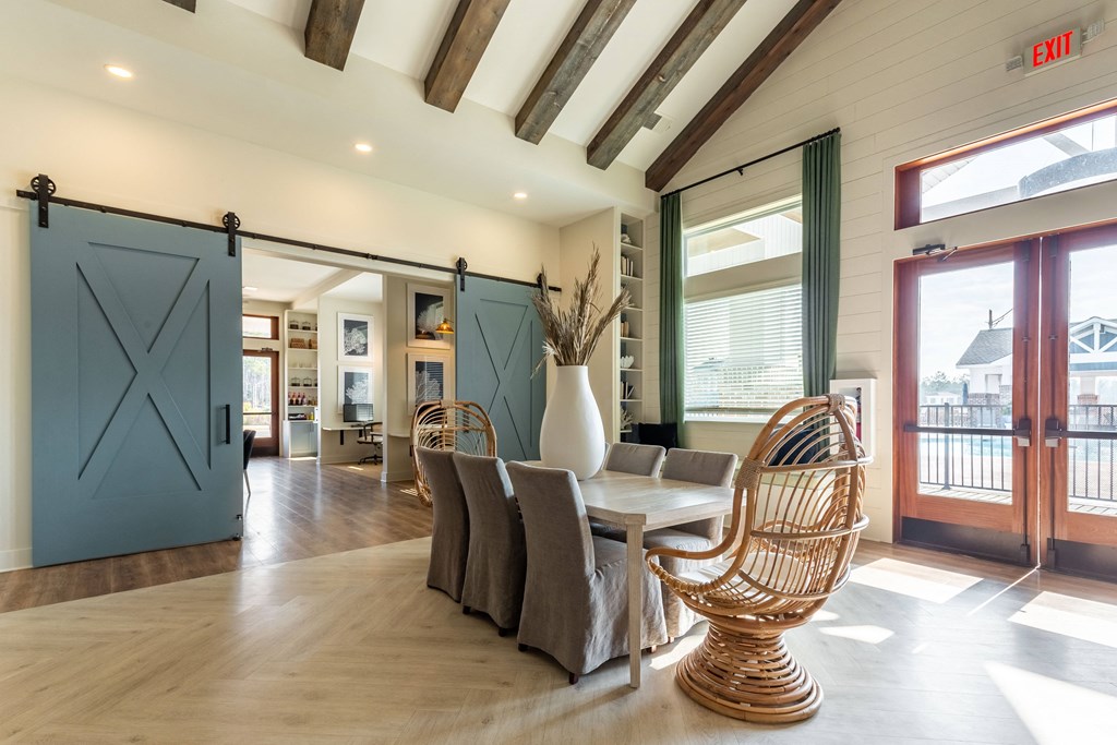 Amenities a dining room with a table and chairs and sliding barn doors