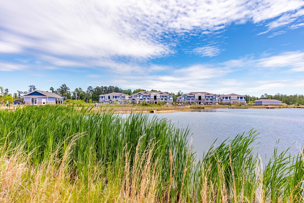 a view of a lake with houses in the background
